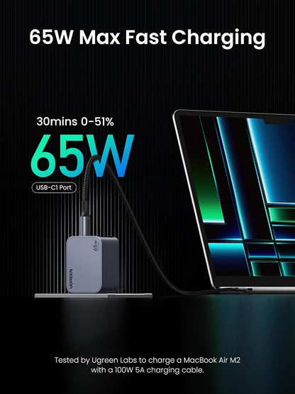 65W fast charging adapter with laptop on black background